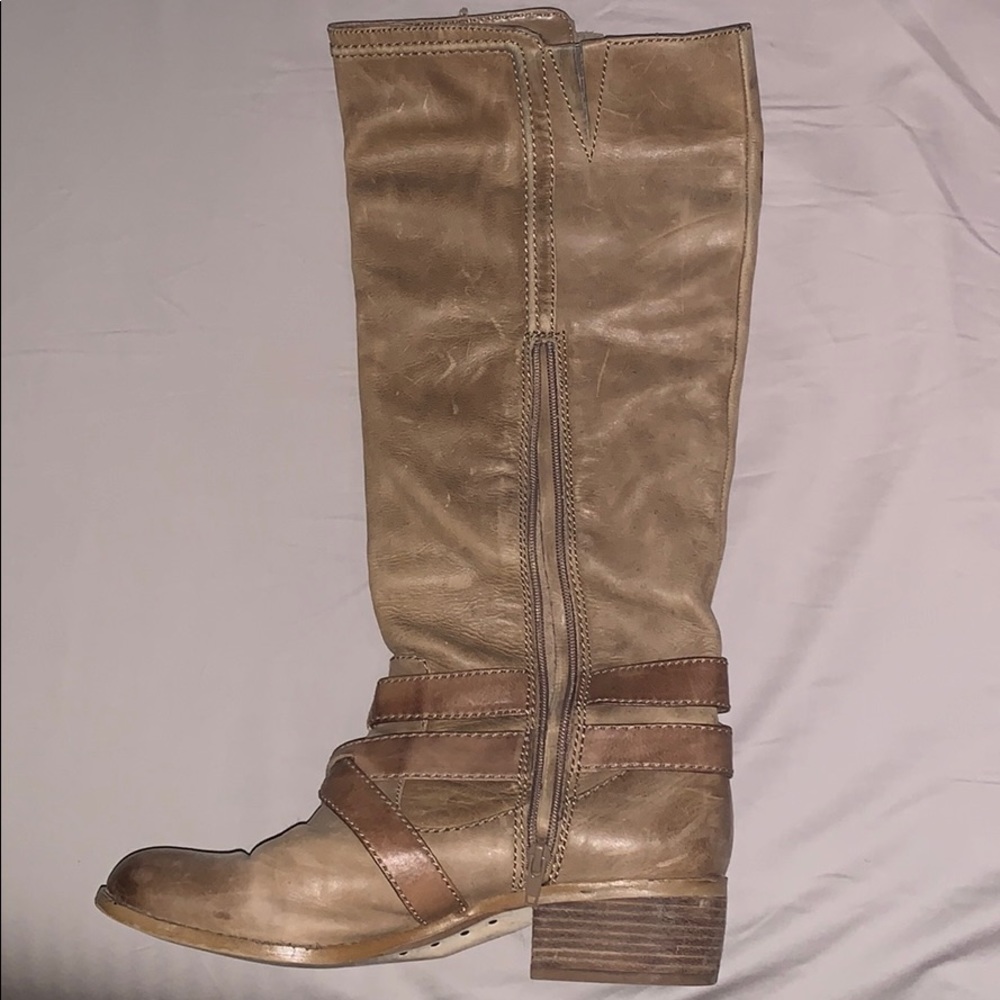 Leather boots with straps and buckles.